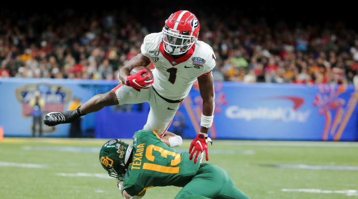 Jan 1, 2020; New Orleans, Louisiana, USA; Georgia Bulldogs wide receiver George Pickens (1) leaps over Baylor Bears cornerback Raleigh Texada (13) during the second quarter at the Mercedes-Benz Superdome.